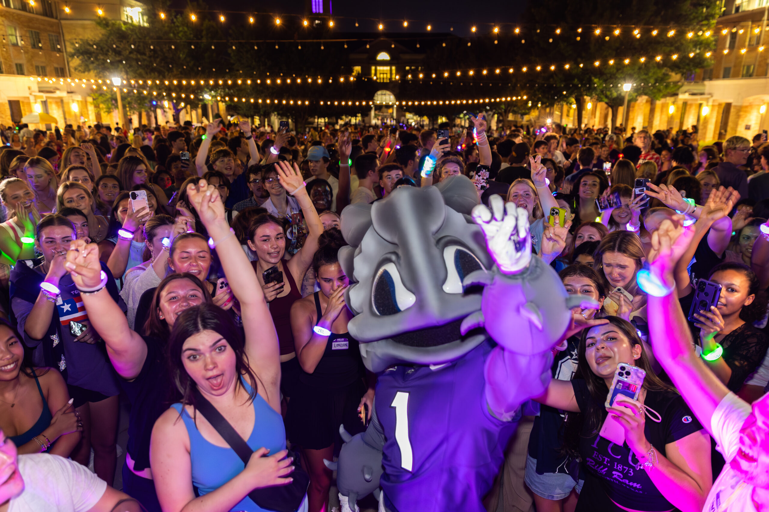 Students dancing in the Campus Commons with SuperFrog.
